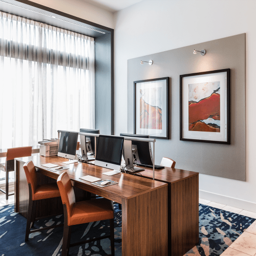 Stunning resident lounge with ample seating options, a large flatscreen TV, shuffleboard and billiards at Solaire 7077 Woodmont in Bethesda, Maryland