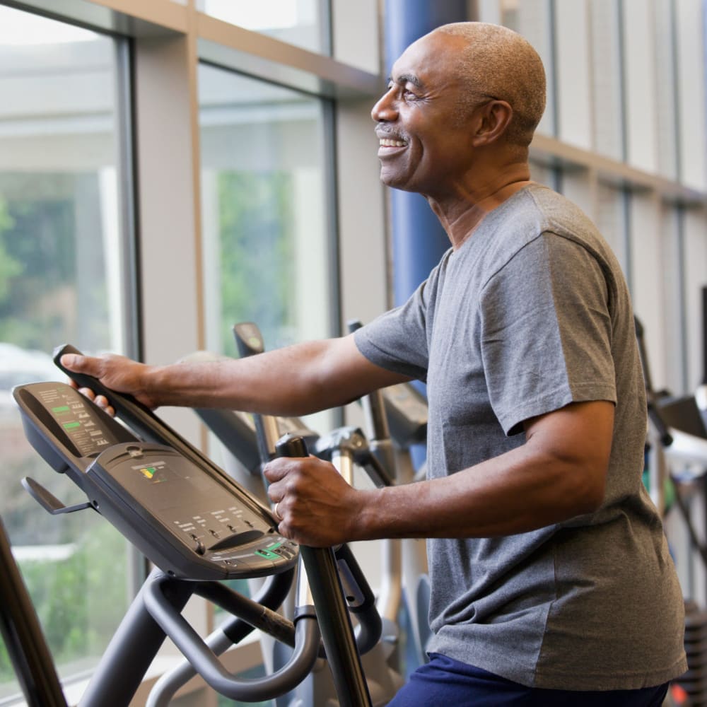 A resident working out on an elliptical machine at The Peaks at South Jordan in South Jordan, Utah