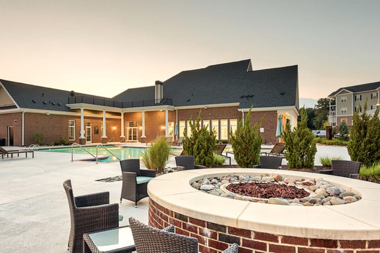 Community lounge area next to an outdoor firepit at Meridian Obici in Suffolk, Virginia