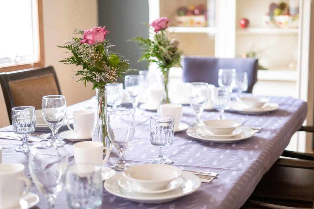 Elegant dining setting complete with beautiful flowers at Brookstone Estates of Vandalia in Vandalia, Illinois