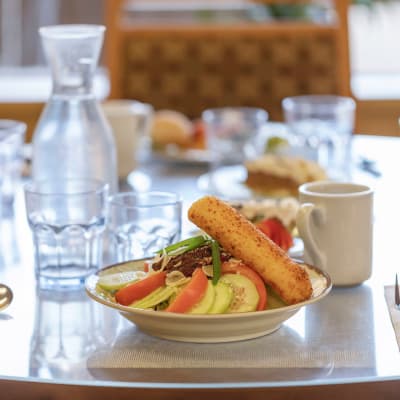 Table set with a fresh salad and breadstick at 6th Ave Senior Living in Tacoma, Washington