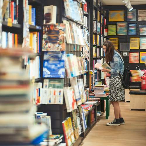 Resident browsing a book store at 1801L Apartments in Sacramento, California