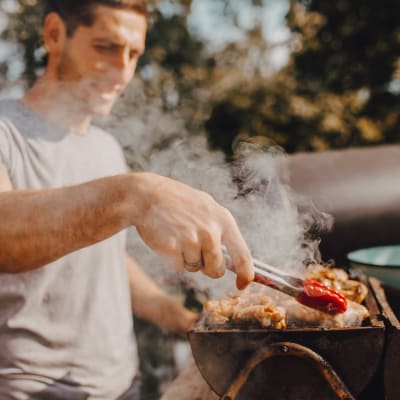 A resident grilling food at Chollas Heights in San Diego, California