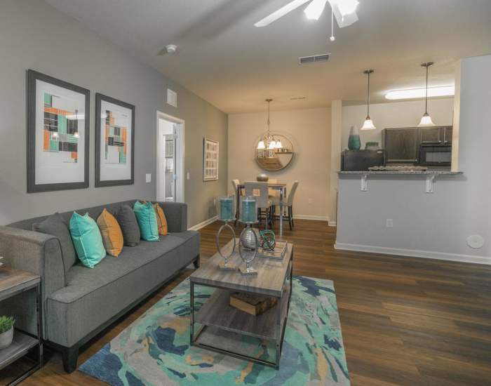 Living room with vinyl flooring, ceiling fan, comfortable couch and a coffee table at The Haven At West Melbourne in West Melbourne, Florida