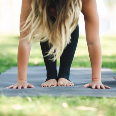 Resident doing yoga in a park near Aston Pointe in Aston, Pennsylvania