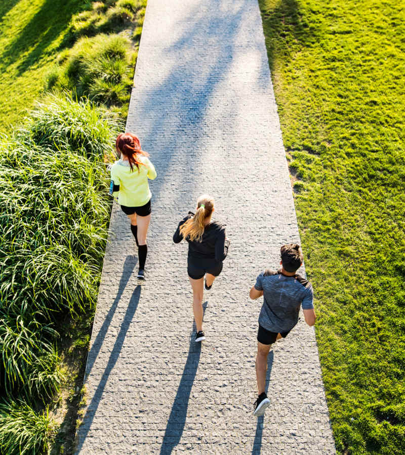 Group of friends jogging on a path near Waters Edge in Sacramento, California
