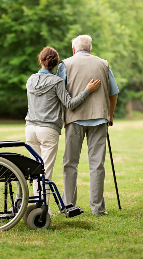 Elderly couple out for a walk outdoors at Pillars Senior Living in Lakeville, Minnesota