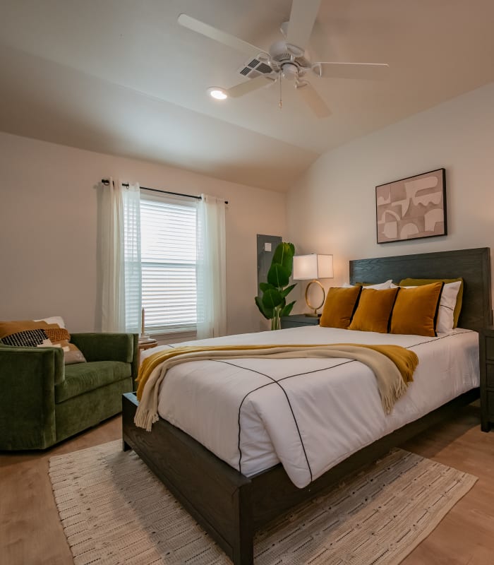 Model bedroom with sitting area at Chisholm Pointe in Oklahoma City, Oklahoma