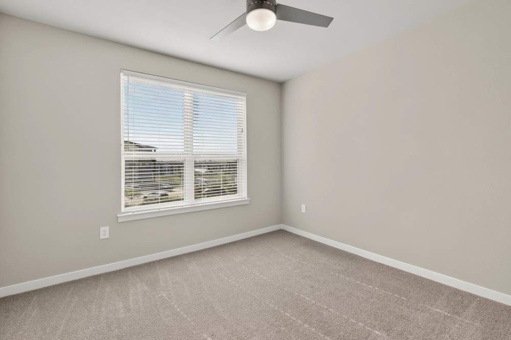 Bedroom with large window at The Springs at Georgetown in Georgetown, Texas