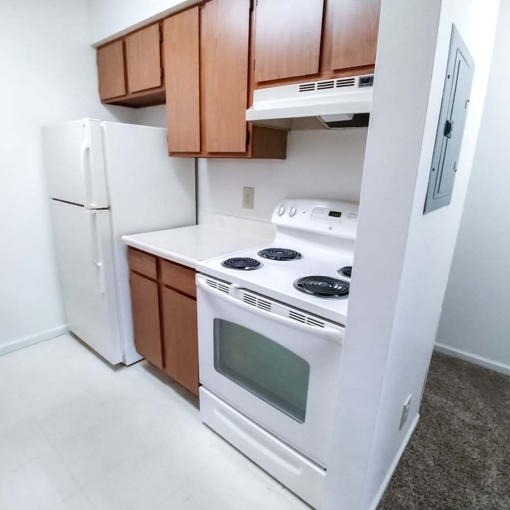 Kitchen with white appliances at Mill Pond (Brooklyn) in Brooklyn, Michigan