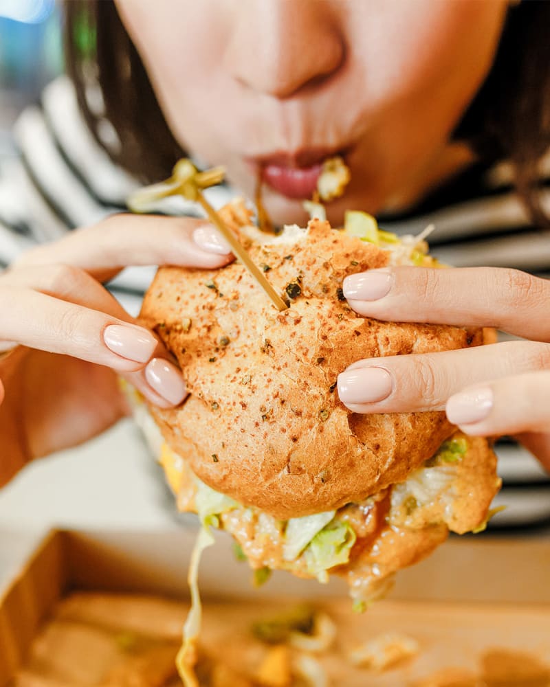 Resident eating a burger near Magnolia Heights in Covington, Georgia