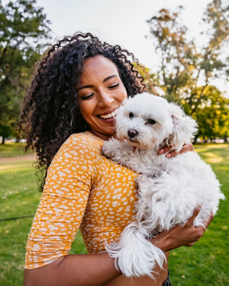 Resident holding a small dog at Magnolia Heights in Covington, Georgia