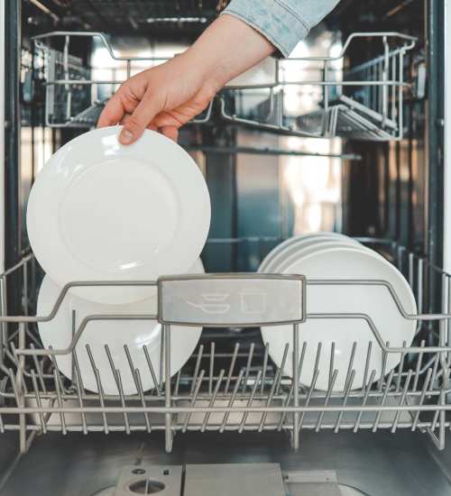 Resident using the dishwasher at Twyckenham Apartments in Lafayette, Indiana