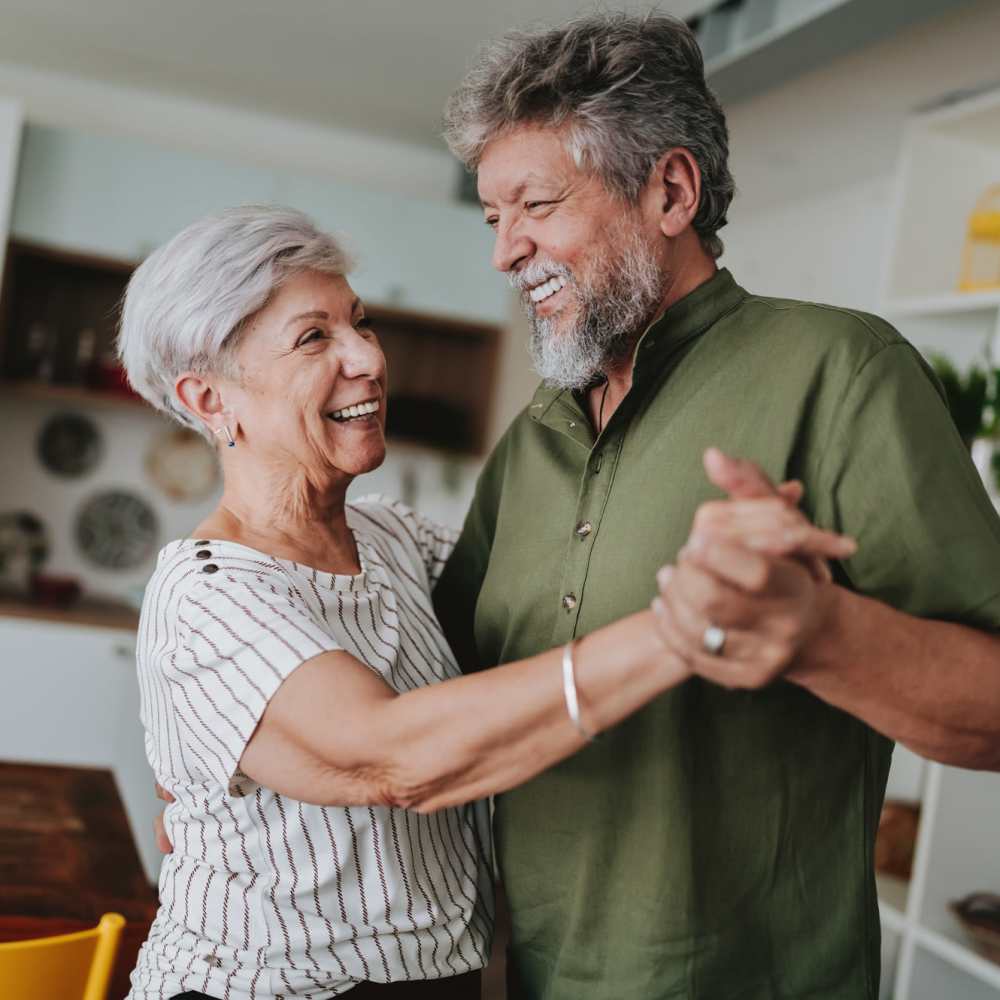 Resident couple dancing in their new home at The Cascade at Foundry Creek in Richmond, Virginia