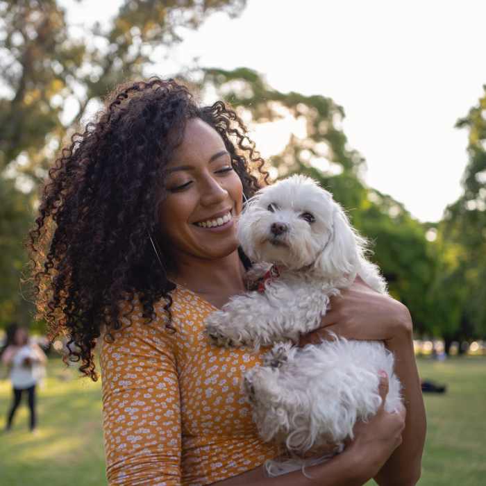 Resident woman cuddling her pet at Creekwood Place in Lancaster, Texas
