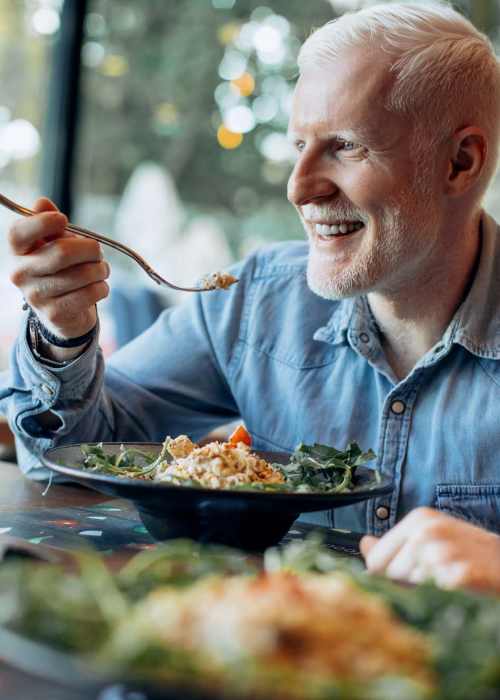 Happy resident having meal at Elan Manatee in Bradenton, Florida