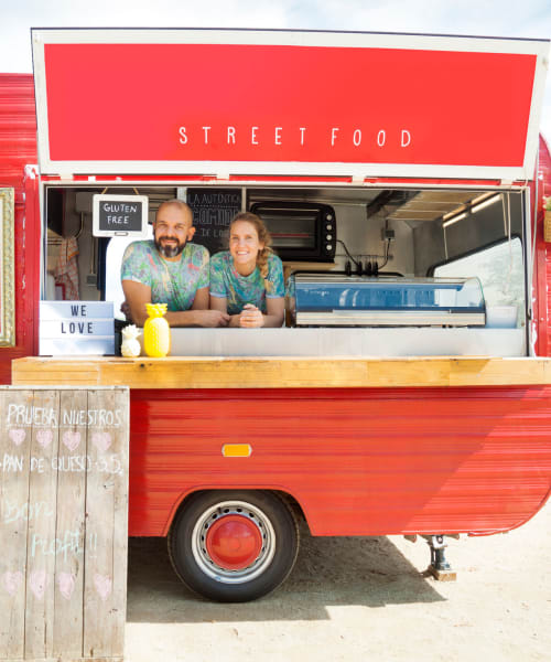 A man and woman working at a food cart near Grand Meridia Apartments in Rahway, New Jersey