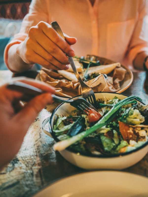 Two people having salad at a restaurant near Palmhouse Jacksonville in Jacksonville, Florida