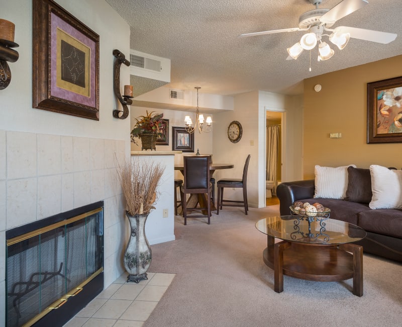 Comfortably decorated living area with a fireplace and an accent wall in a model home at The Mansion in Independence, Missouri
