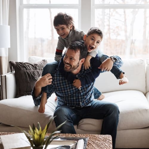 A father playing with his sons at Midway Manor in Virginia Beach, Virginia