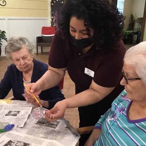 Resident showing off her painted nails at Oxford Glen Memory Care at Grand Prairie in Grand Prairie, Texas