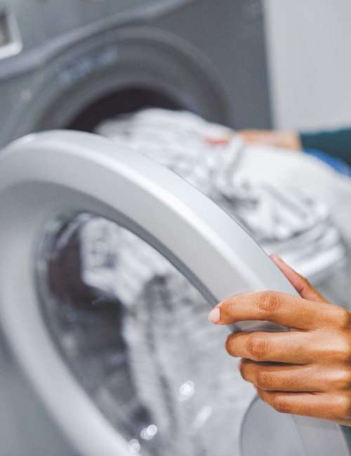 A resident using laundry services at Meadowview Apartments in Anoka, Minnesota