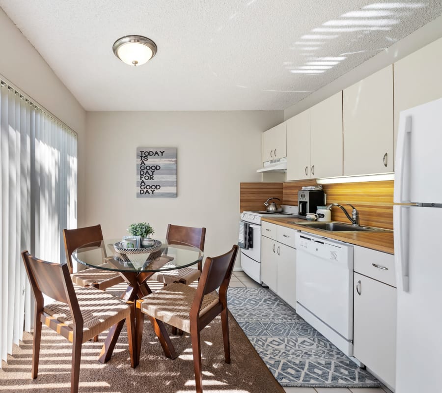 Dining area and open modern kitchen with full appliance package  at Executive Apartments in Miami Lakes, Florida