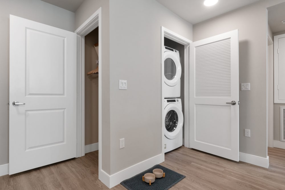 A stacked washer and dryer in a home at Alivia Townhomes in Whittier, California