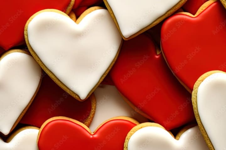 Heart-shaped, shortbread cookies with red and white icing