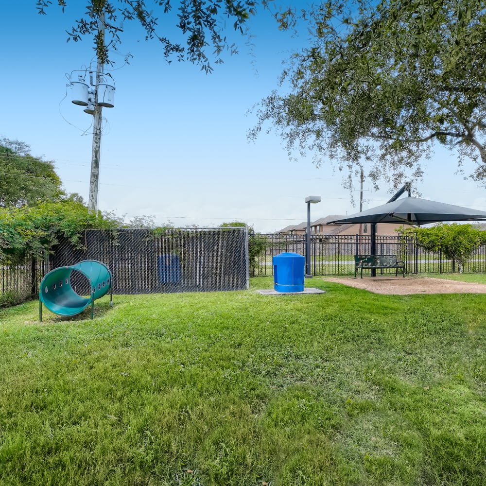 Fenced dog park and off-leash recreation area at Grand Villas Apartments in Katy, Texas