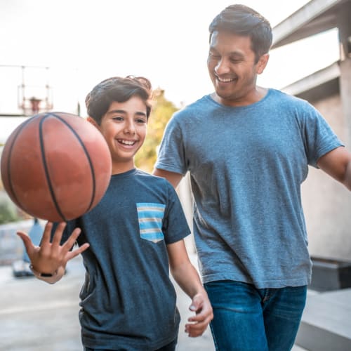 a resident and son playing basketball at Bayview Hills in San Diego, California