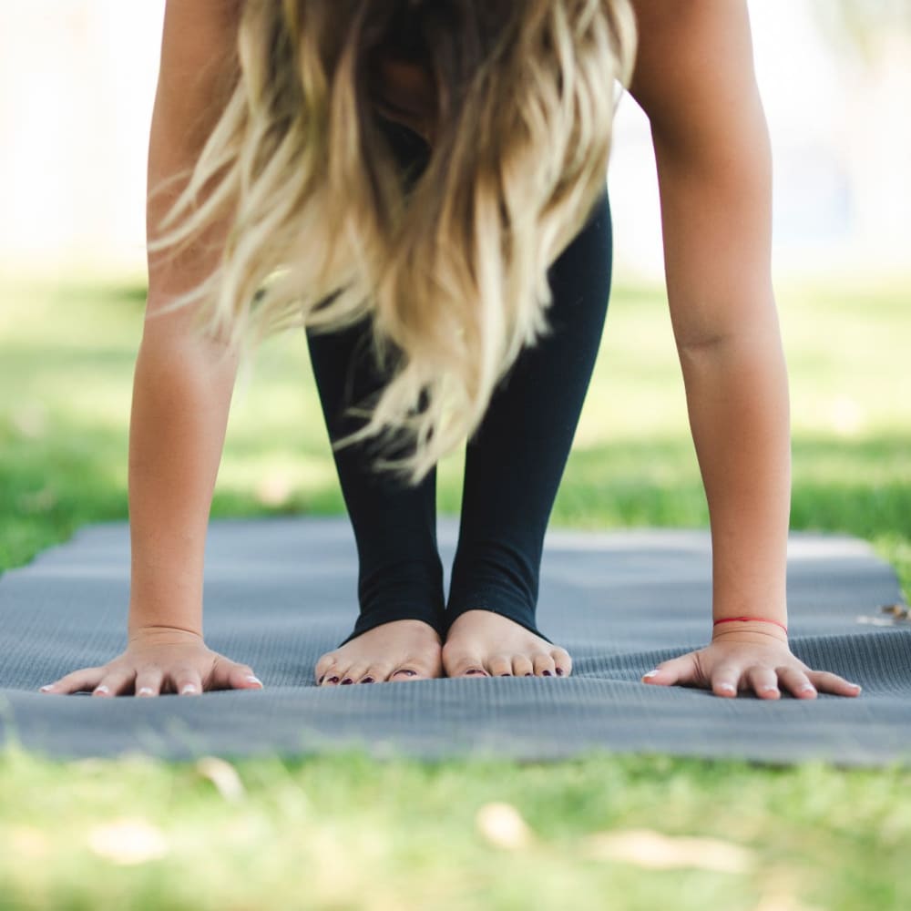 Resident doing yoga in a park near Ashley Park Apartments in Stockton, California