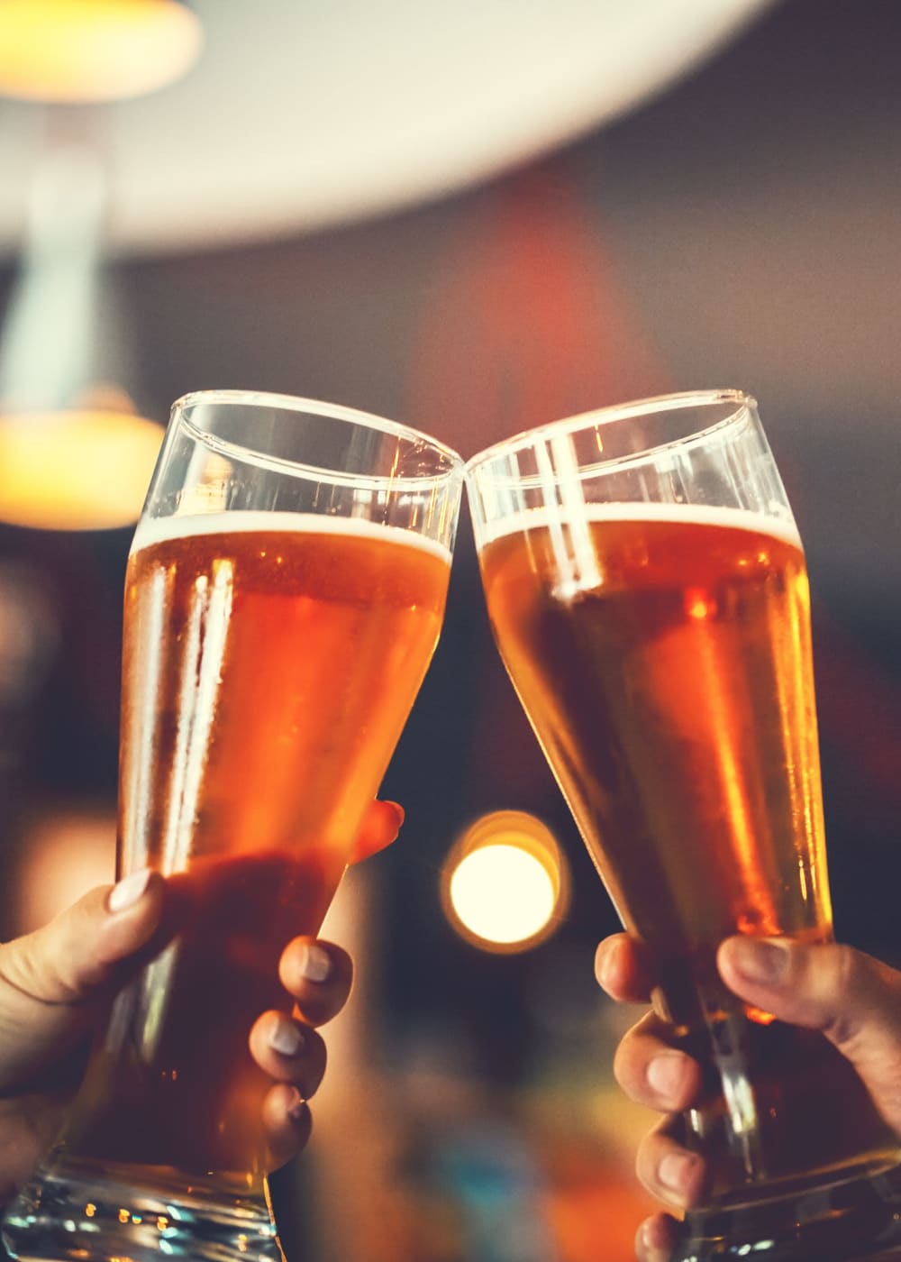 Friends raising glasses in a cheerful toast at a cozy local bar near Haven Hills in Vancouver, Washington   