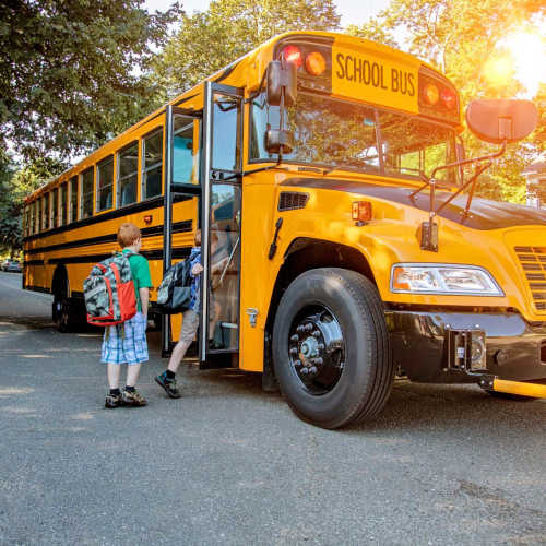 Resident children going to the school bus at Corrigan Square Apartments in Gaithersburg, Maryland