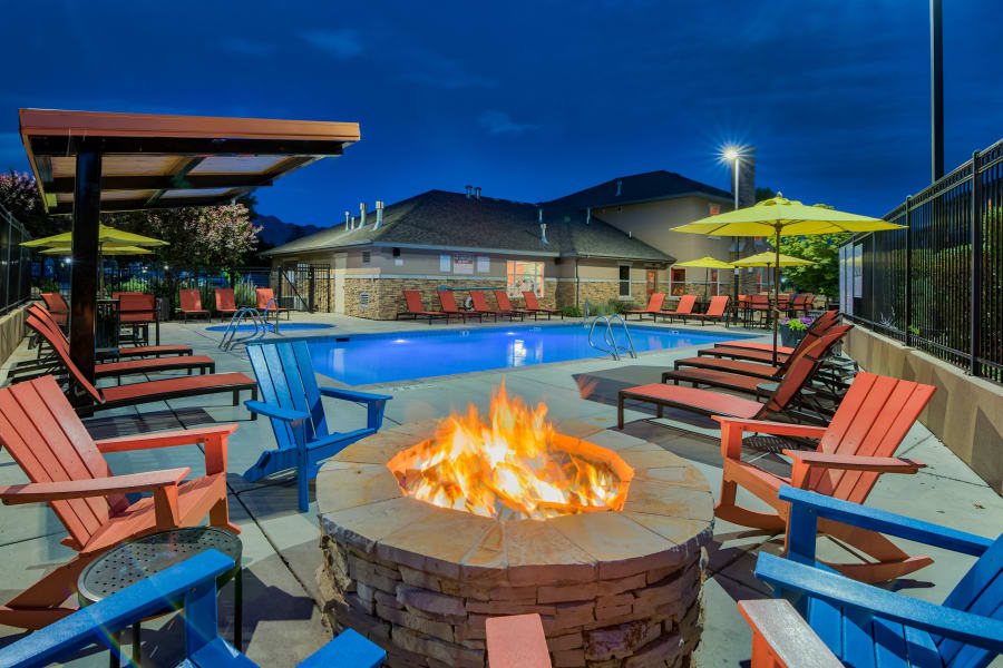 Fire pit area near the pool at dusk at Meadowbrook Station Apartments in Salt Lake City, Utah