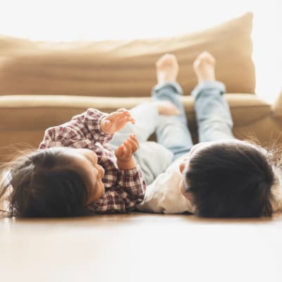 Kids with feet up on couch in a living room at Copper Canyon in Twentynine Palms, California