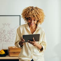 A woman looking at a tablet at The Alexandria in Madison, Alabama