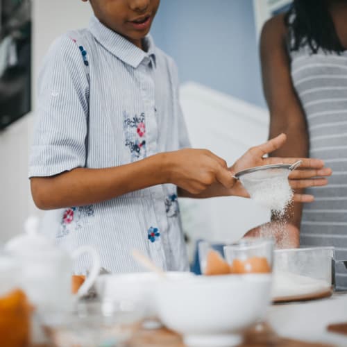 A mother and her son baking in a home at Gateway Village in San Diego, California