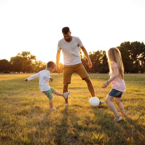 Resident playing with his children near Seapointe Villas in Costa Mesa, California