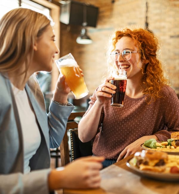 Two women having drinks together in a restaurant near The Lively Indigo Run in Ladson, South Carolina