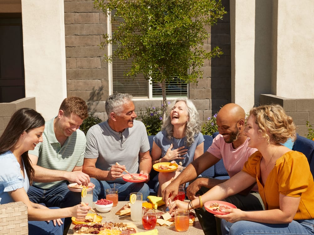 Residents enjoying food and drinks outside at BB Living at Val Vista in Gilbert, Arizona