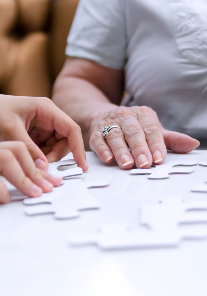 A caregiver and resident put together a puzzle at Lighthouse Memory Care in Anacortes, Washington