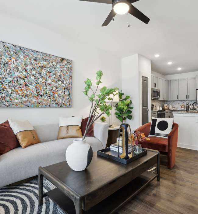 A furnished apartment living room and kitchen at The Southerly at Orange City in Orange City, Florida