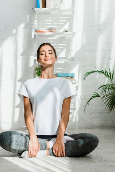 Resident sitting on the floor doing some meditating at Rivertop Apartments in Nashville, Tennessee