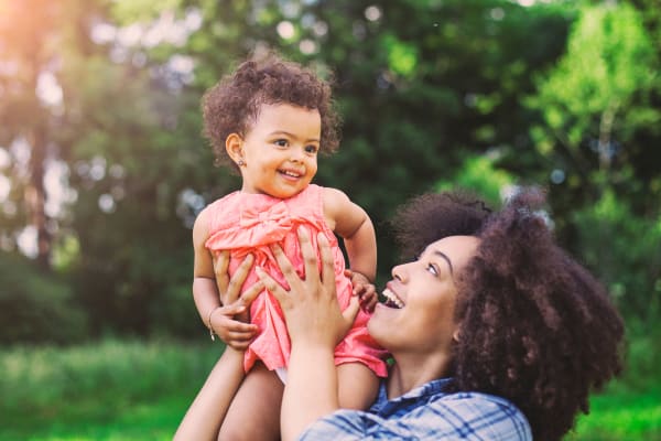 Resident and child at a park near River Ridge Apartments in Tualatin, Oregon