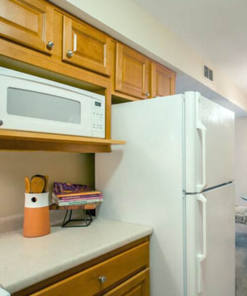 Kitchen with white appliances at Beau Jardin Apartments in St. Louis, Missouri