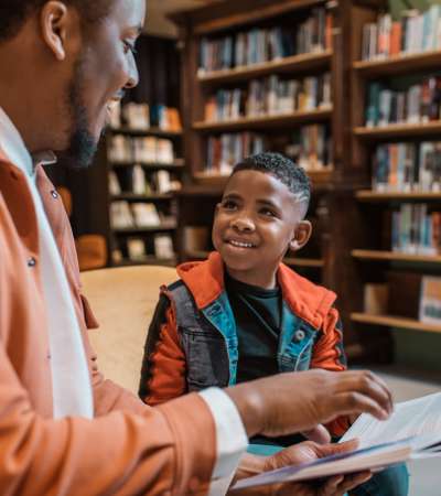 Resident teaching his son through a book at Thickett in Mt Pleasant, South Carolina