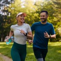 A couple jogging in a park near Palisades at Lewis Creek in Wilmington, North Carolina