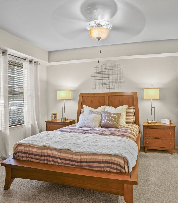 Spacious carpeted bedroom at Cottages at Tallgrass Point Apartments in Owasso, Oklahoma