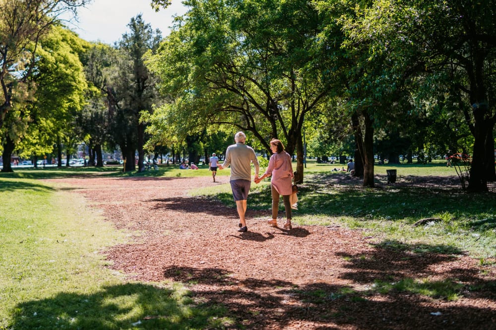 Couple taking a walk through a park near The Pointe at Siena Ridge in Davenport, Florida